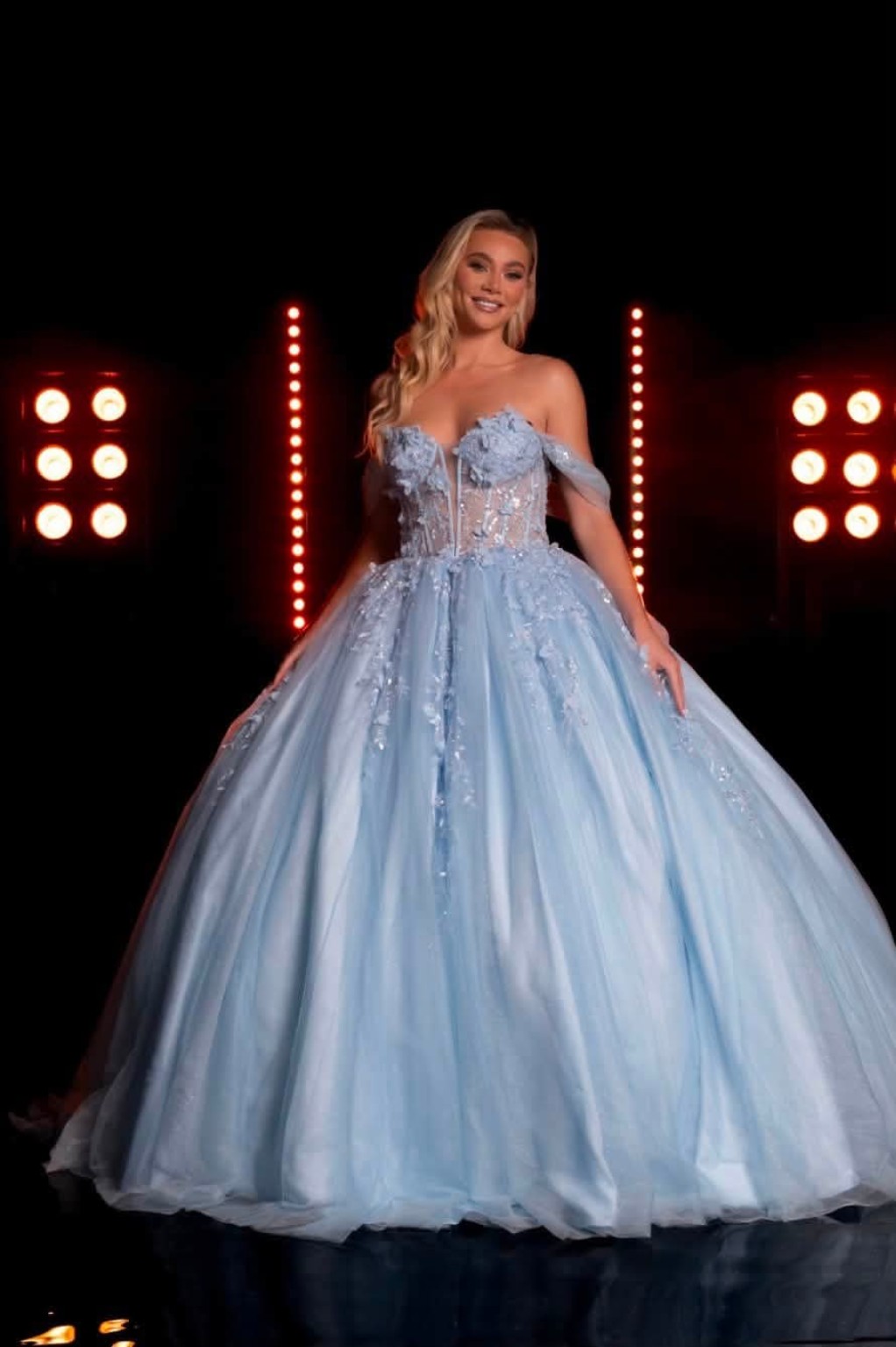 Pale blue ballgown under runway lights
