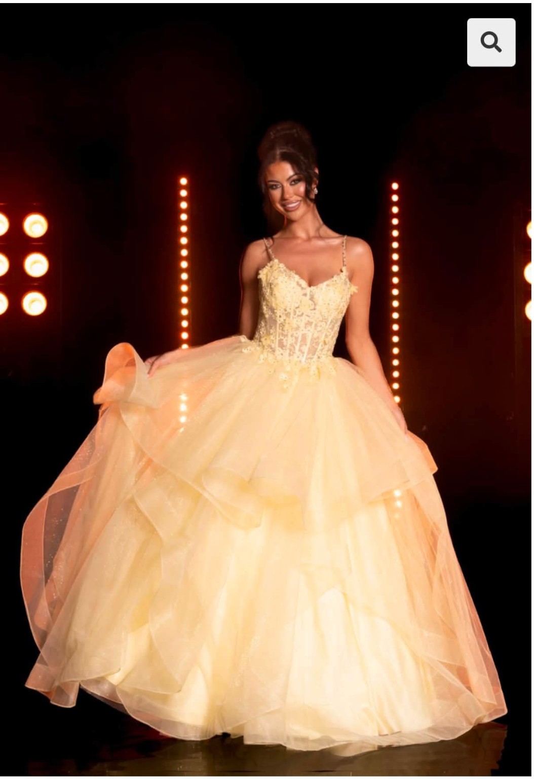 Champagne ballgown beneath warm runway lights